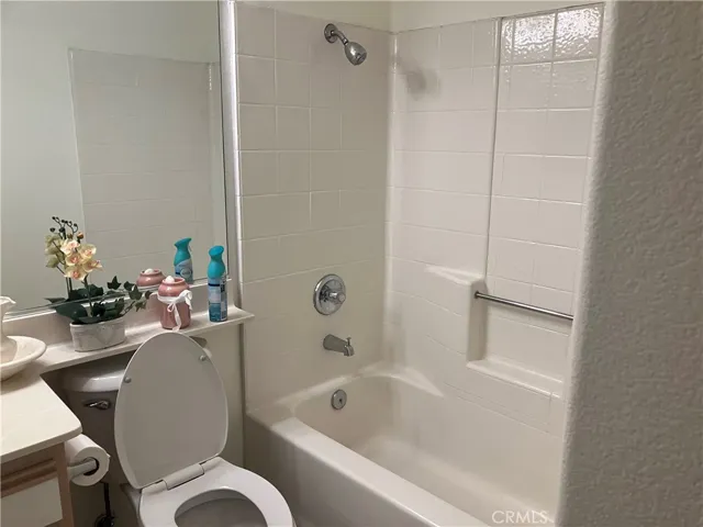 Bathtub in bathroom near second bedroom.