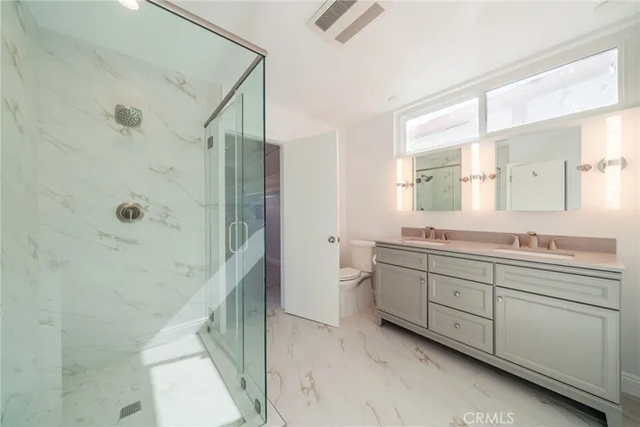 Primary bathroom with shower and dual sink countertop