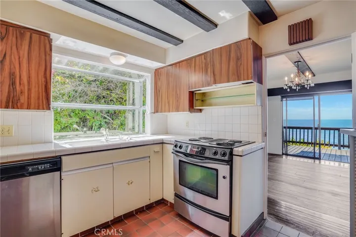 Kitchen and separate dining room that opens up to ocean view deck.
