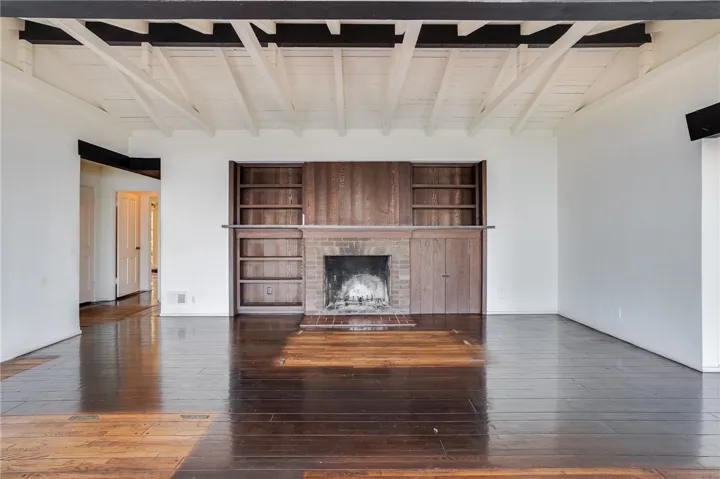 Primary great room anchored by fireplace.