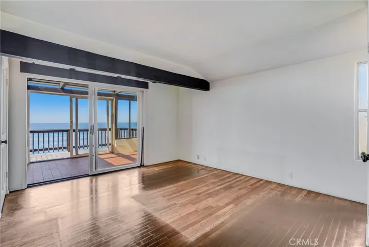 Main level bedroom #1 with ocean view sun room attached.