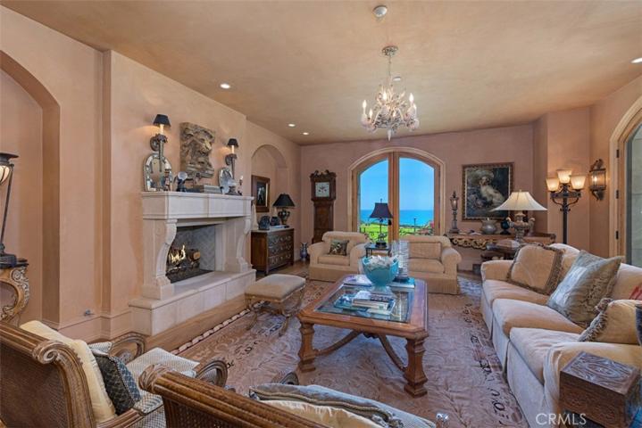 Living Room with Plaster walls looks out over ocean.  Fireplace for cozy settings.