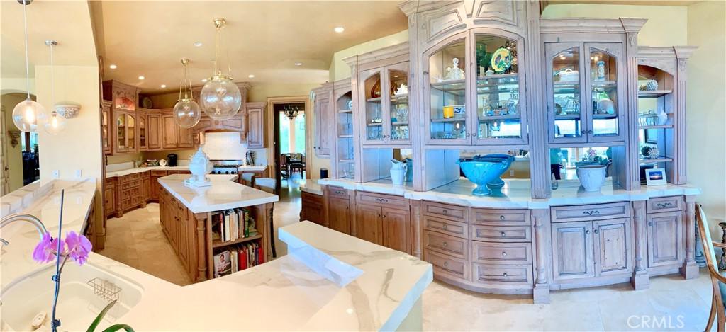 Kitchen has Center Island and lots of storage.  Distressed wood cabinets, the reclaimed fir came from a rescued barn in Oklahoma.