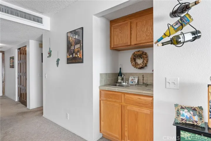 Entertain in style with the convenience of a built-in wet bar in the living room!
