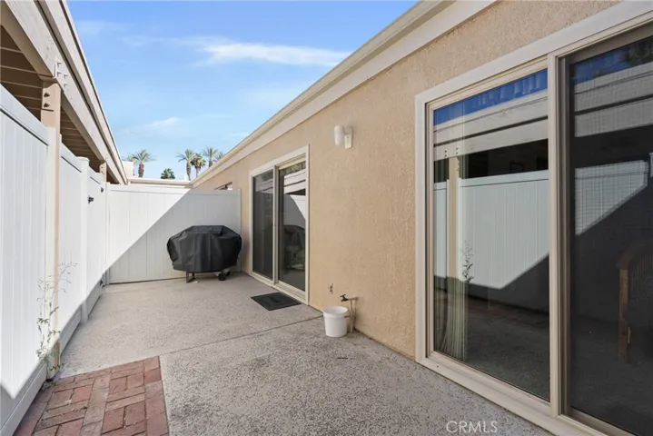 Private patio with vinyl fencing for outdoor relaxation and dining.
