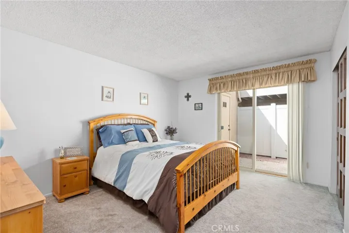 The primary bedroom offers an inviting space with direct access to the back patio!