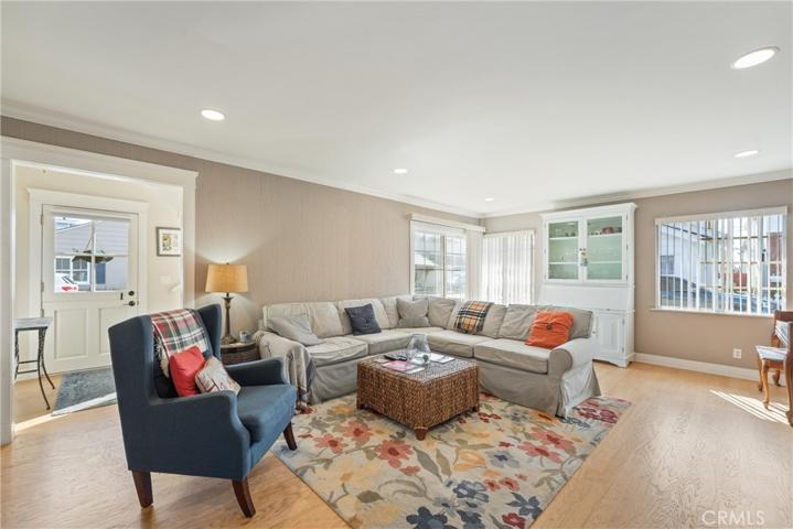 Large Living Room with slider in the corner and canned lights.