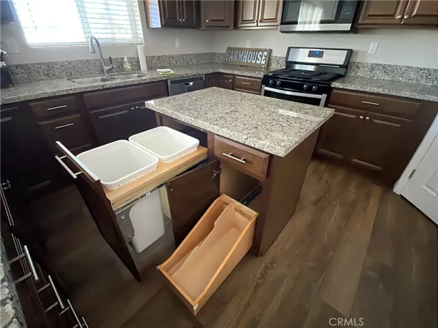 Kitchen Island has a potential trash/recycling bin storage and baking sheet Storage