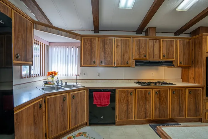Kitchen has sink overlooking view out front