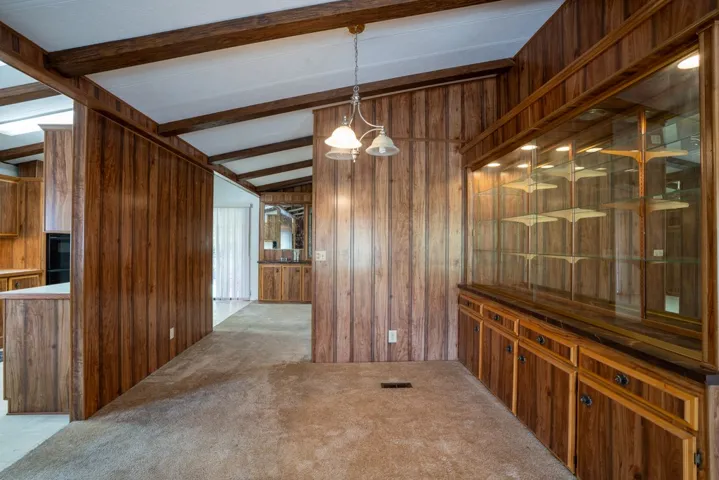 Dining area looking into kitchen on left and family room at rear