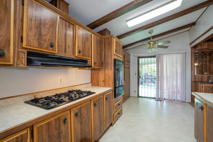 Kitchen looking into eating area with sliding door on to patio