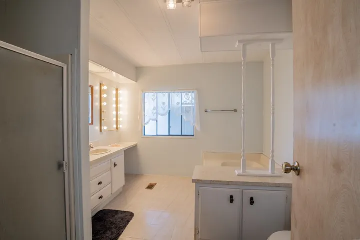 Main bath has two sinks, shower, bathtub and storage cabinets