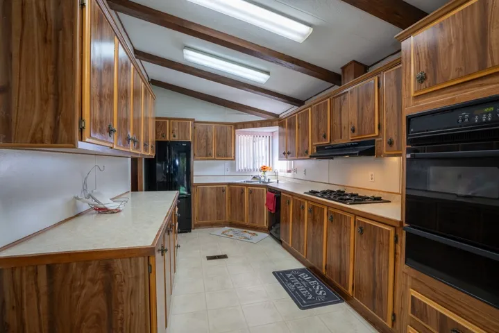 Kitchen has refrigerator, dishwasher, oven and lots of cupboards and counter space