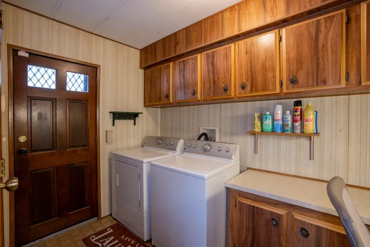 Laundry room showing back door to carport