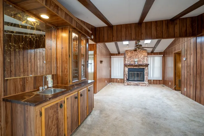 Family room with fireplace and entrance to laundry room on the right