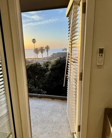 Door to balcony located next to desk