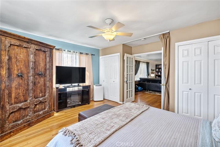 Bedroom with double door entry and dual closets