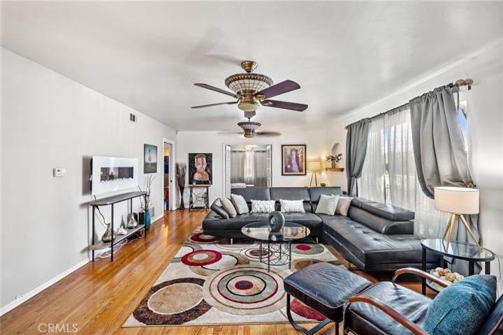 Spacious living room with glass stain fans and matching fixtures