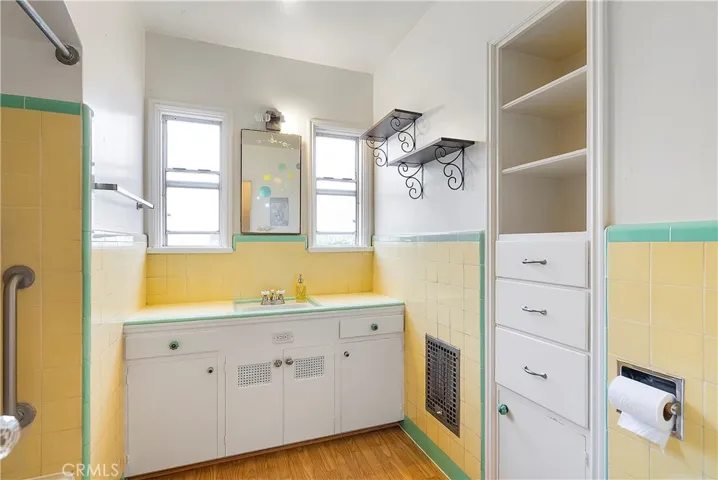 Stunning vintage bathroom with built-in linen cabinetry.