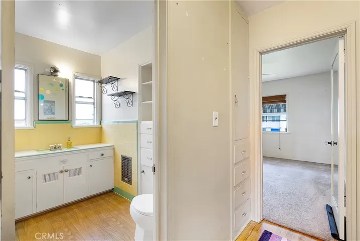 View of bathroom and hallway leading to one of the two bedrooms.
