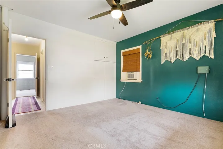 Bedroom #1 with view into hallway.