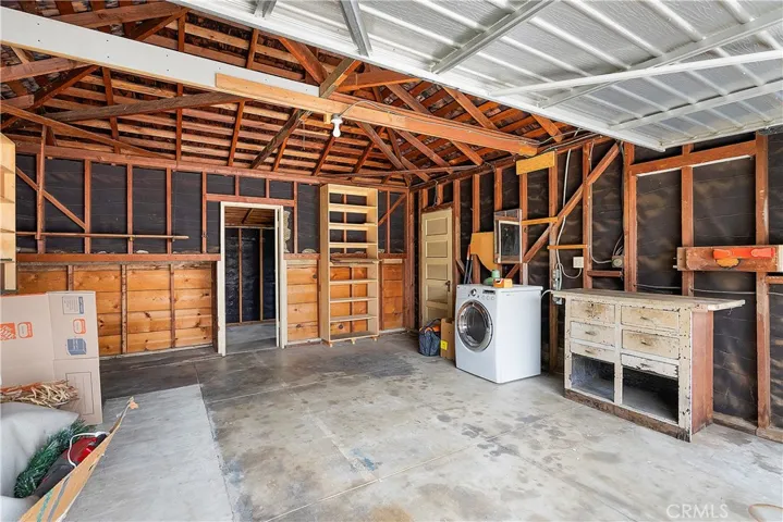 Garage interior with doorway to dedicated workshop.