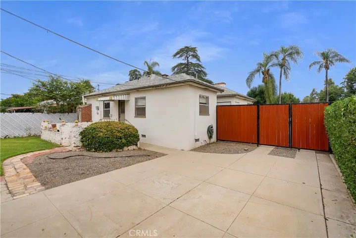 View from garage of back of house and privacy gate on driveway.
