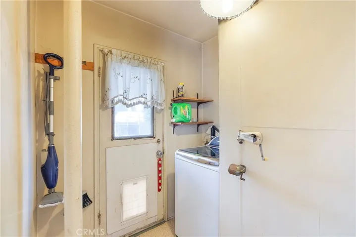 Inside laundry room with washing machine. Dryer is in garage, but maybe a stackable would fit in this room.