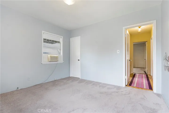 Bedroom #2 with view into hallway.