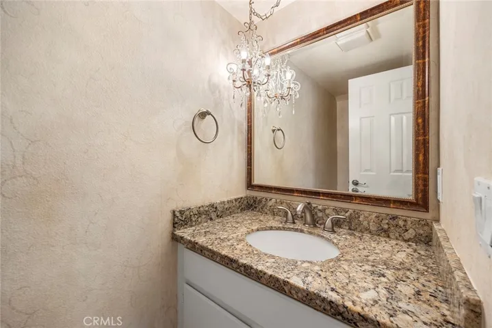Downstairs 1/2 bath/powder room with granite counters.