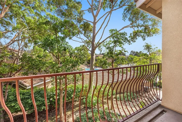 Balcony overlooks pool area and hills of Anaheim Hills.