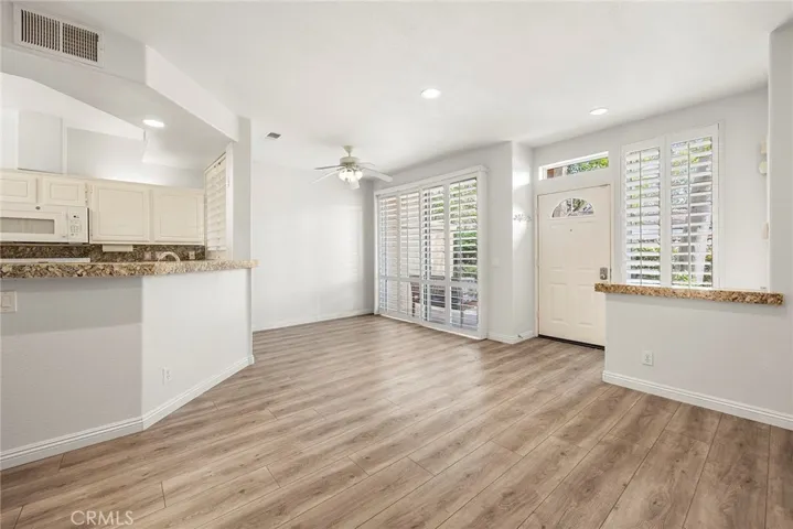 Living room overlooks dining room and covered patio.