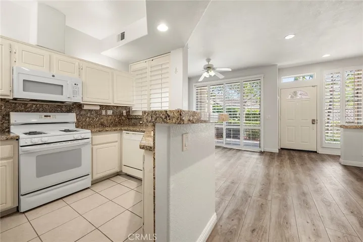 Kitchen overlooks living room and dining room.