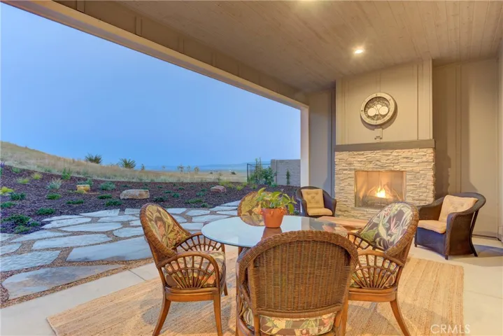 Outdoor covered patio with extended stone patio