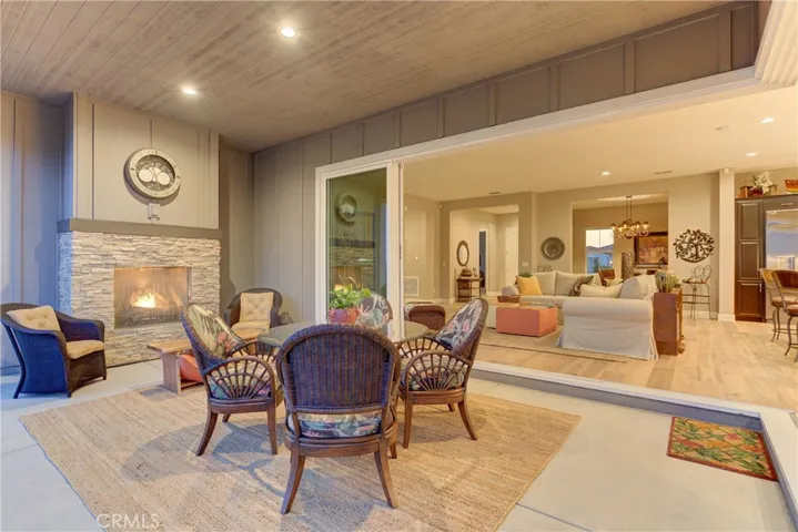 Covered outdoor patio with gas-burning fireplace.