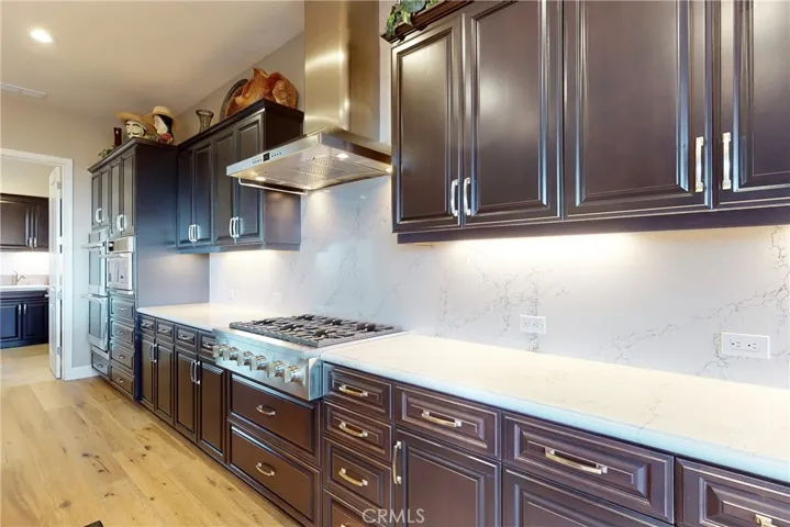 Custom Quartz countertops, back splash and GE Monogram 6-burner Gas Cooktop