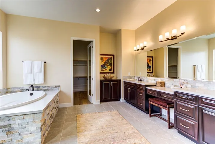 Fantastic Master Bathroom has a walk-in shower with a seamless glass enclosure, separate tub, dual sinks and a walk-in closet with lots of storage space
