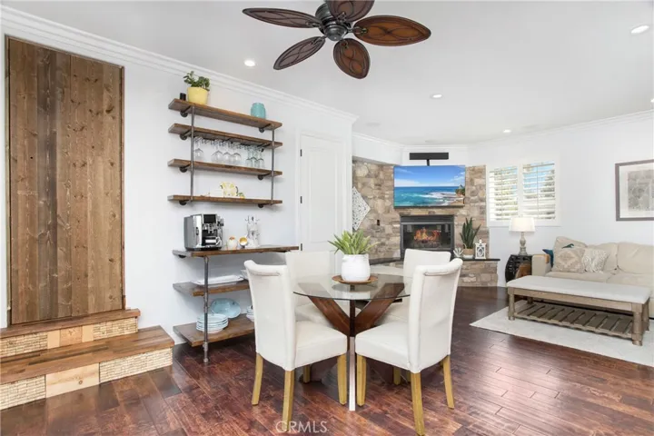 Dining area with rustic shelving and view of fireplace