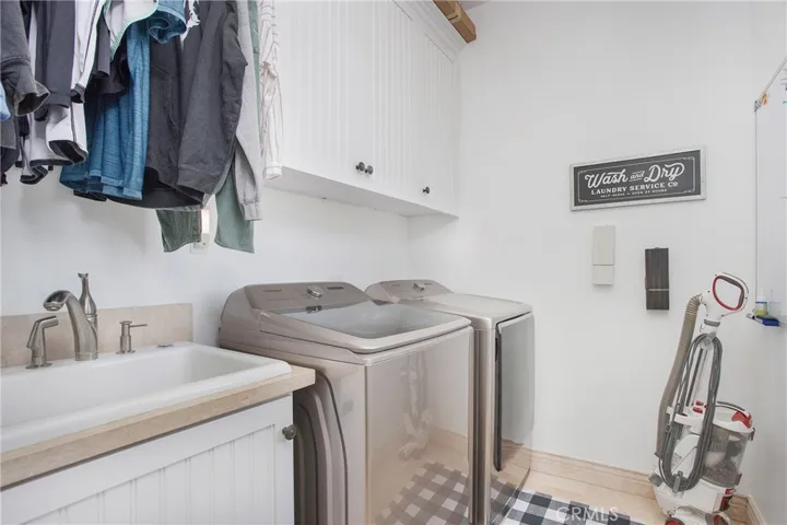 Upstairs laundry with sink and hanging space!