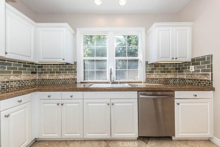 Kitchen with stainless steel appliances and granite counters