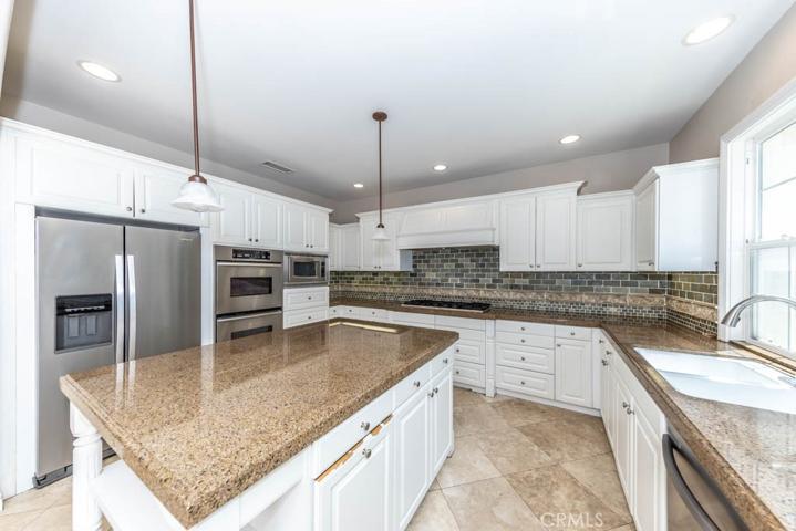 Kitchen with stainless steel appliances and granite counters