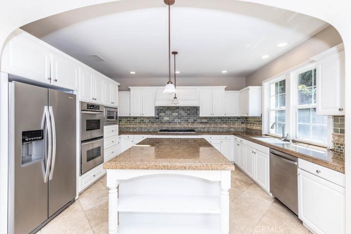 Kitchen with stainless steel appliances and granite counters