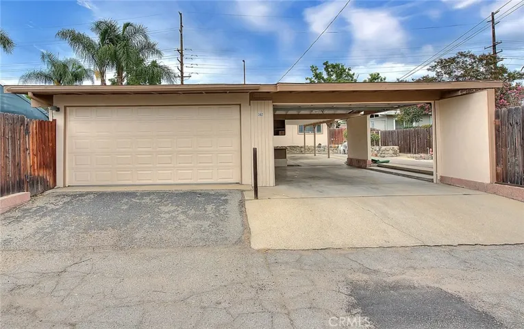 Two car garage with attached two car carport with garage door and you can drive through and park another car under the carport.  For a total of 5 covered space.   Great for a car collector or a family with many drivers.