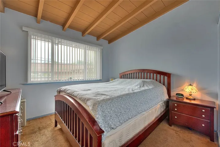 primary bedroom has wood ceilings and big picture window