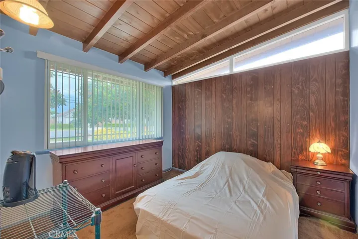 Bedroom number 2 has a large picture window with views of front yard and you might sneak a peak at the mountains.  Wood ceiling and wood paneling add a lovely feature.