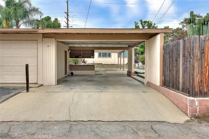 This covered carpet has one additional space to pull through and a garage door to add privacy to your backyard.