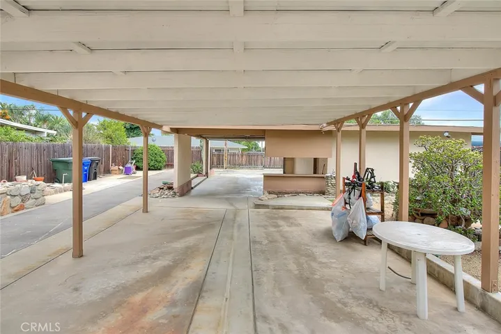 This covered carport can be used for a car or BBQ area or anything that fits your family needs.
