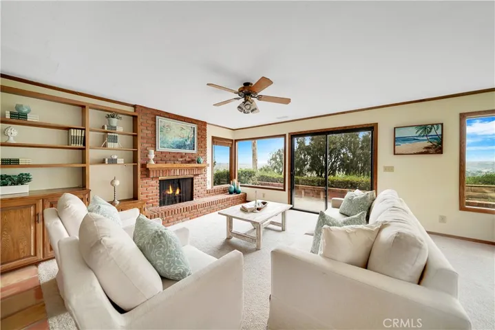 Plus, another fireplace to enjoy!  A raised hearth makes for more seating in the family room and a built in bookcase/desk is well used space.
