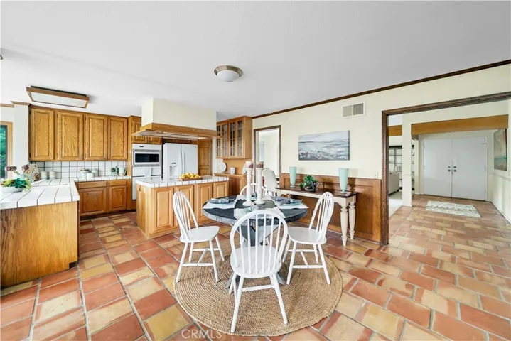 Efficient kitchen has lots of counter space, cooktop in the island and lots of storage.
