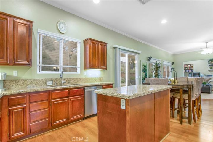 Upgraded Kitchen with granite counters and windows overlooking the back-yard